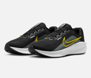Side view of Nike Downshifter 13 running shoes for men in sleek black and white design