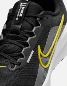 Nike logo close-up on Downshifter 13 running shoes highlighting brand authenticity